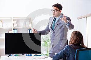 Young employee making presentation to his female boss