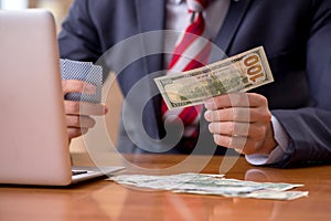 Young male employee playing cards at workplace