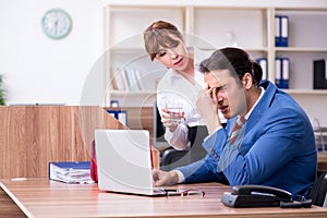 Young employee suffering in the office