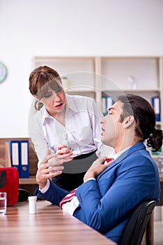 Young employee suffering in the office