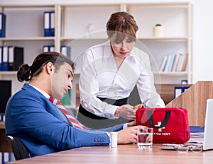 Young employee suffering in the office