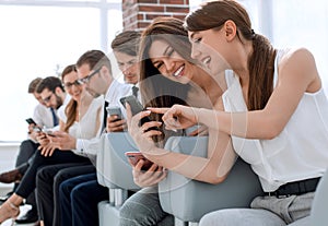 Young employees of the company using their gadgets