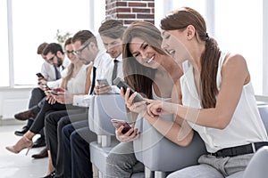 Young employees of the company using their gadgets