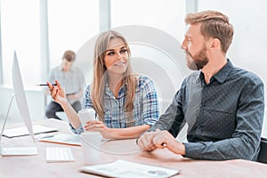 Young employees discussing the information coming to the office.