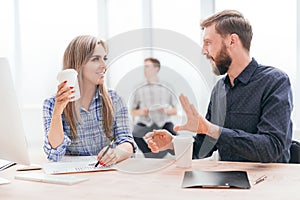 Young employees discussing something during the coffee break.