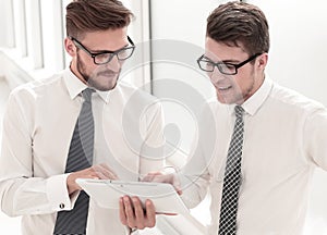 Young employees looking at the digital tablet screen