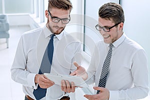 Young employees looking at the digital tablet screen