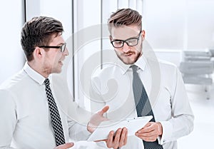 Young employees looking at the digital tablet screen