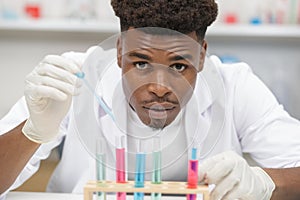 young energetic scientist loads liquid sample in tube