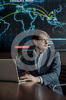 Young it engeneer business man with thin modern aluminium laptop in network server room