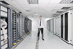 Young engeneer in datacenter server room