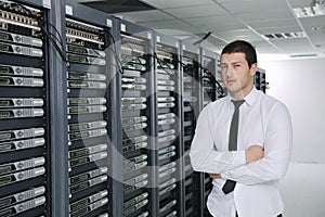 Young engeneer in datacenter server room