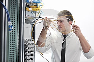 Young engeneer in datacenter server room