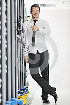 Young engeneer in datacenter server room