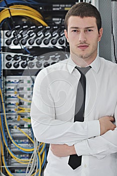 Young engeneer in datacenter server room