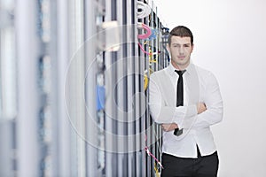 Young engeneer in datacenter server room