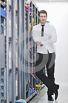 Young engeneer in datacenter server room