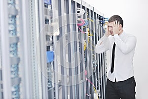 Young engeneer in datacenter server room