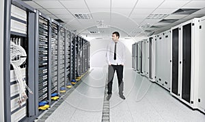 Young engeneer in datacenter server room