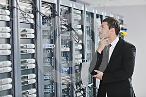 Young engeneer in datacenter server room