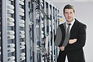 Young engeneer in datacenter server room