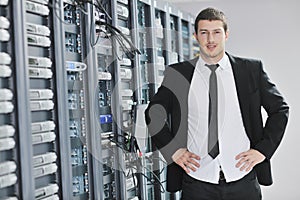 Young engeneer in datacenter server room