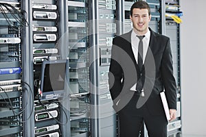 Young engeneer in datacenter server room