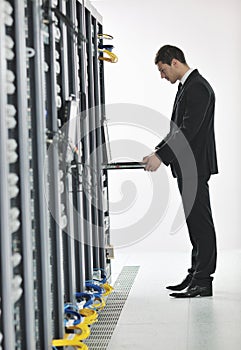 Young engeneer in datacenter server room