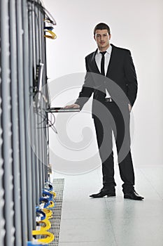 Young engeneer in datacenter server room