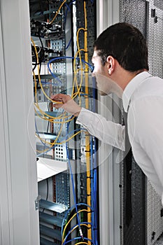 Young engeneer in datacenter server room