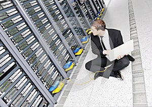 Young it engeneer in datacenter server room