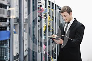 Young it engeneer in datacenter server room