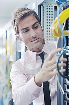 Young it engeneer in datacenter server room