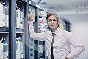 Young it engeneer in datacenter server room