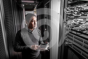 Young engineer businessman in server room