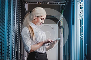 Young engineer businesswoman in network server room