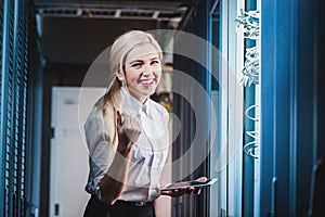 Young engineer businesswoman in network server room