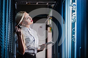 Young engineer businesswoman in network server room