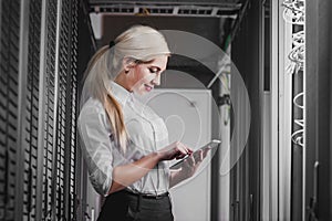 Young engineer businesswoman in network server room
