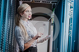 Young engineer businesswoman in server room