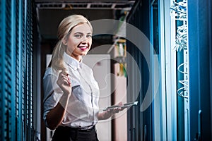 Young engineer businesswoman in server room