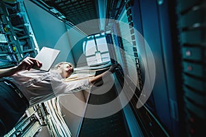 Young engineer businesswoman in server room