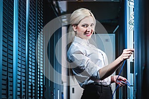 Young engineer businesswoman in server room