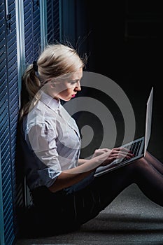 Young engineer businesswoman in server room