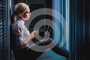 Young engineer businesswoman in server room