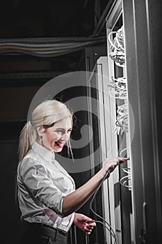 Young engineer businesswoman in server room