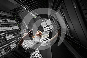 Young engineer businesswoman in server room