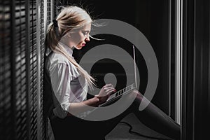 Young engineer businesswoman in server room