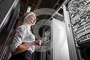 Young engineer businesswoman in server room