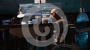 Young engineer with chronic disability working on IT software coding